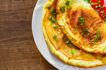 omelette in a white plate on wooden table