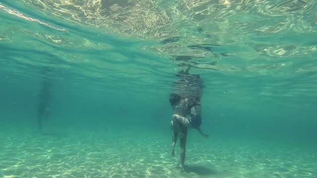 girls in thong play underwater