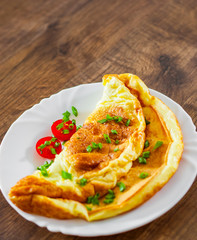omelette in a white plate on wooden table