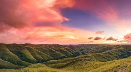 Poster Colorful sunset sky over mountain panorama, Merdeka Hill, Bukit Wairinding, East Sumba, Indonesia. Bright pink, blue, green colors. Travel Background. Nature landscape. Untouched wild island © Goinyk