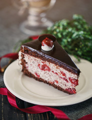 A piece of chocolate cake with cherries