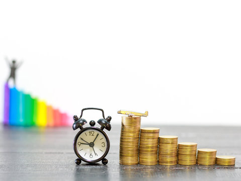 coins stack and clock and aircraft on wooden table, finance and investment concept ,growing money ,