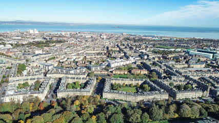 Aerial image looking across the north of the city of Edinburgh to Leith docks and the Firth of Forth on a bright autumn day.