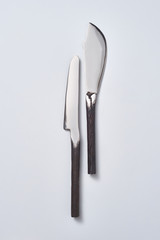 Two vintage knives presented on a gray background with copy space for text. Flat lay