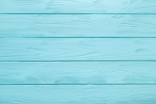 Fototapeta Light blue plank texture of wood table. Coloured background.