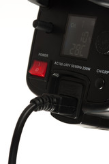 Close-up - side view - the back panel of a professional black studio illuminator with power button. Studio equipment concept