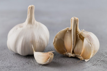 Garlic heads close-up on grey background. Condiment.