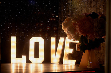 Glowing letters love in the design of a party or night club. Valentine's day