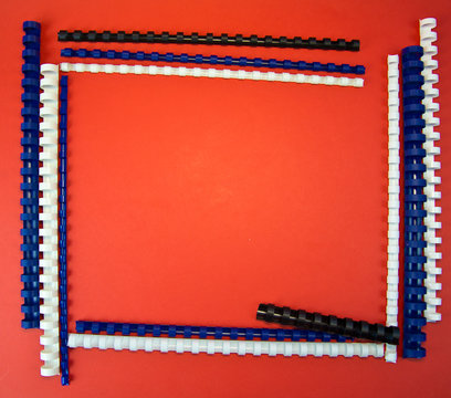 color plastic binding spring frame on red background