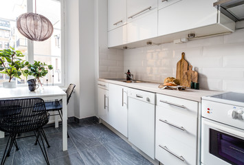 kitchen interior with bread on the countertop table by the window and grey tiled floor