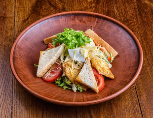 The dish with pork, tomatoes and croutons