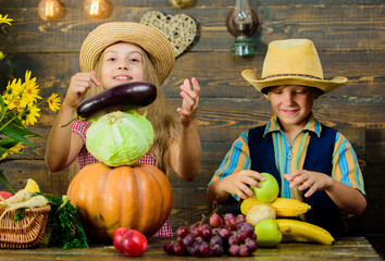 Celebrate harvest holiday. Elementary school fall festival idea. Autumn harvest festival. Children play vegetables pumpkin cabbage. Kids girl boy wear hat celebrate harvest festival rustic style