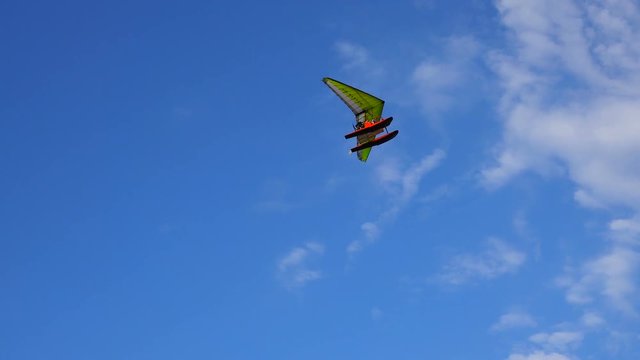 water hang glider flies in the clouds