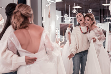 Fototapeta premium We are beautiful. Nice delighted women standing together while looking into the mirror