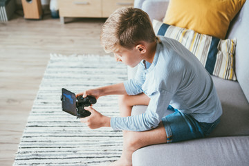 Preteen boy lost in computer game © Soloviova Liudmyla