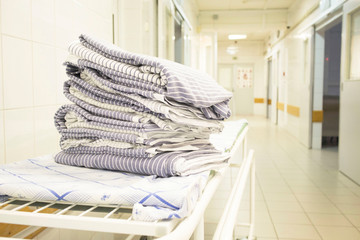 bed linen on hospital bed in hospital corridor. concept of pandemic, coronavirus, virus,...
