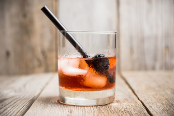 Old fashioned blackberry cocktail on the rustic background. Selective focus. Shallow depth of field.