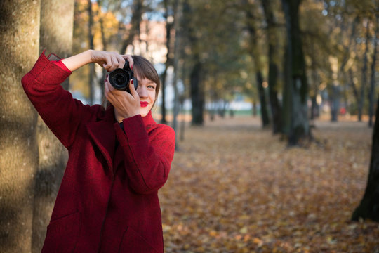Woman with photo camera in park