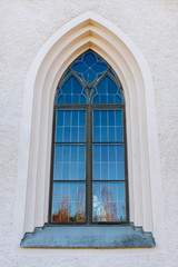 Beautiful vaulted window on a white stone wall