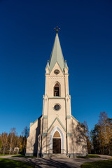 Fototapeta na wymiar White Stone church in autumn sunshine