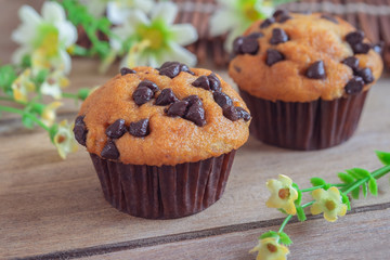 Muffin with chocolate chips on wooden table