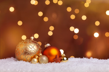 bright christmas background with baubles in snow