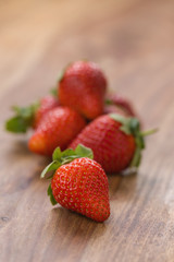 ripe strawberries on wood background