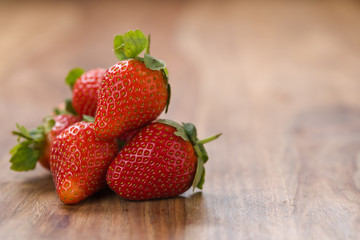 ripe strawberries on wood background with copy space
