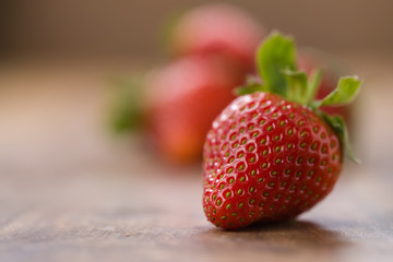 ripe strawberries on wood background with copy space