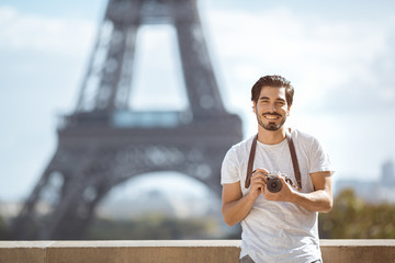 Paris Eiffel Tower tourist with camera taking pictures in front of the Eiffel tower, Paris, France....