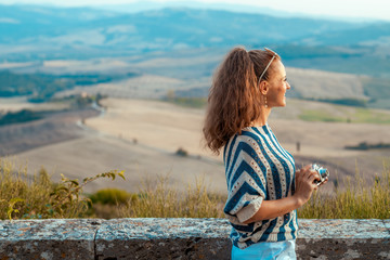 stylish traveller woman with retro photo camera