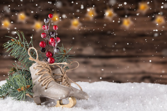 Christmas decoration ice skates on wooden background