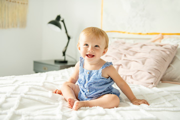 Fototapeta premium Cute baby girl on bed at home