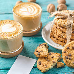 Two glasses of cappuccino and a bunch of oatmeal cookies