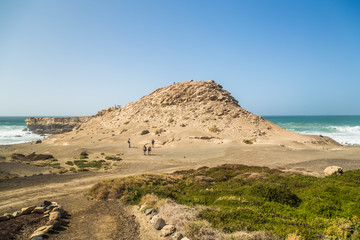 Fototapeta na wymiar Tourists walking on Mirador la Pared on Atlantic coast in Fuerteventura.