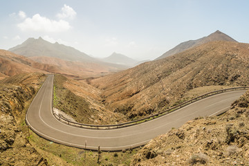 Panoramic view of empty winding road Sicasumbre, Fuerteventura, Spain.
