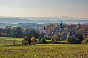 Fototapeta na wymiar Palace and church in Bozkow near Stolowe mountains at autumn, Lower Silesia, Poland