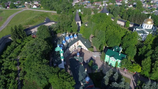 Over the Svyato-Uspensky Pskovo-Pechersky monastery on a Sunny June day. Pechora, Russia (aerial video) 