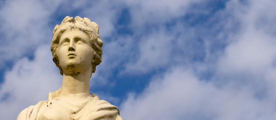 statue of angel on blue sky