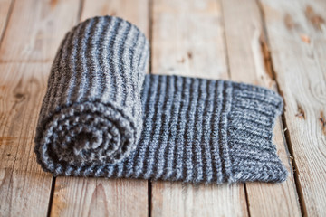 Fototapeta na wymiar Hand knitted gray scarf.