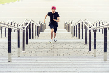 healthy lifestyle. Sporty Young Man Running Upstairs Outdoors