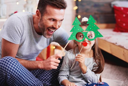 Father And Daughter Having Fun At Christmas Time