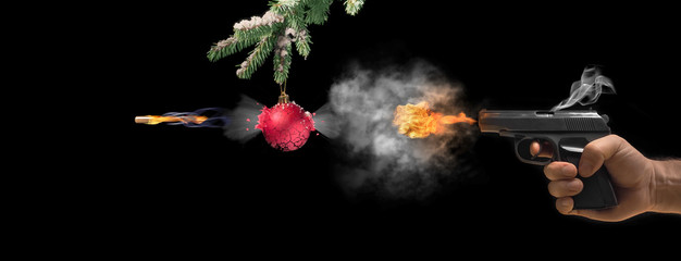 Pistol and Christmas balls on rustic metal background
