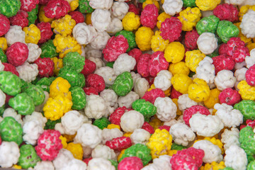 Fototapeta na wymiar Candied peanuts background. peanuts in caramel sugar icing multicolored texture