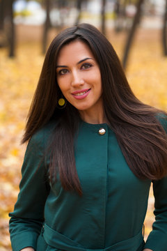 Happy Arabic Woman In Green Coat, Autumn Park Background