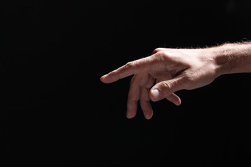 Fototapeta na wymiar open man's hand isolated on a dark background
