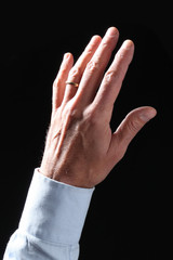 open man's hand isolated on a dark background