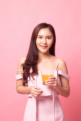 Young Asian woman drink orange juice.