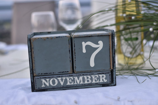 Wood blocks in box with date, day and month 7 November. Wooden blocks calendar