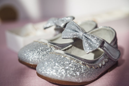 Closeup photo of the shiny shoes of little girl for celebration